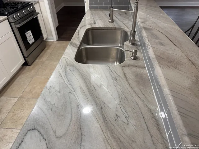 a view of a kitchen counter space and a sink