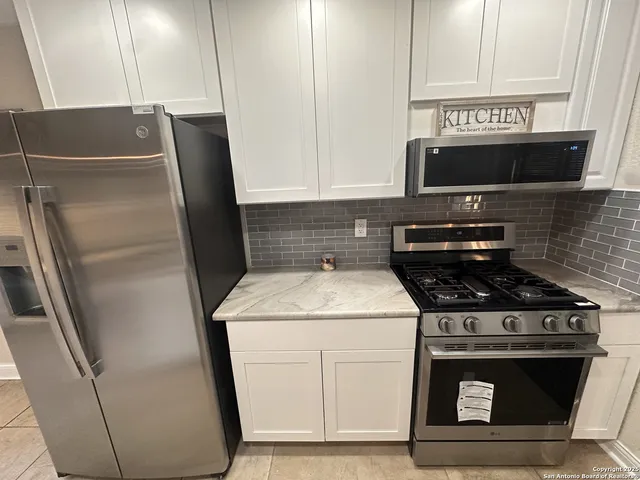 a kitchen with a stove and a refrigerator