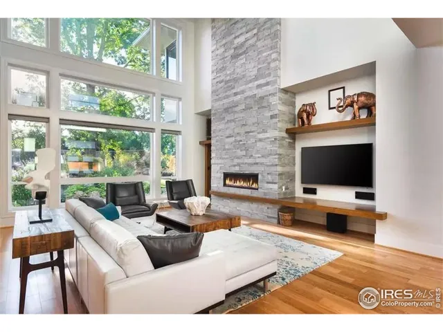 a living room with furniture dining table and a large window