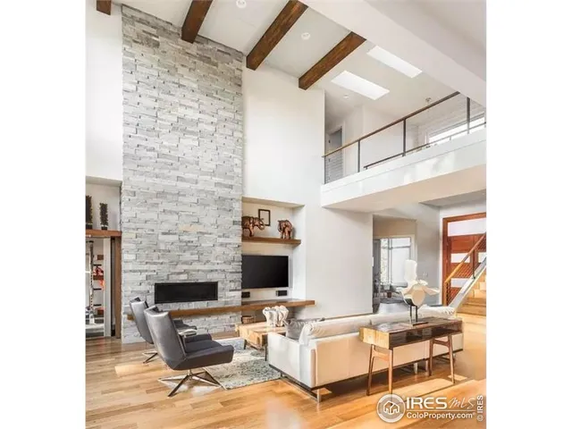 a living room with furniture a rug and a fireplace