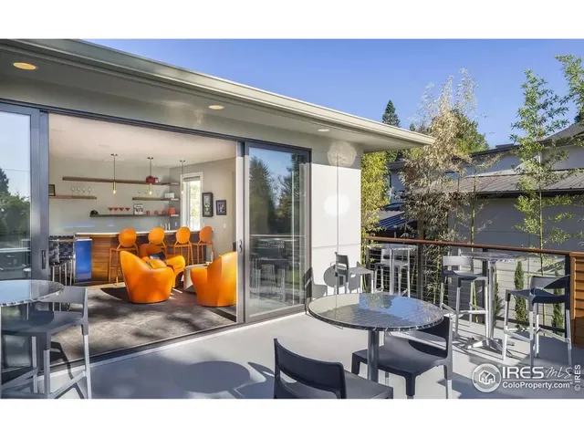 a front view of a house with a yard and potted plants