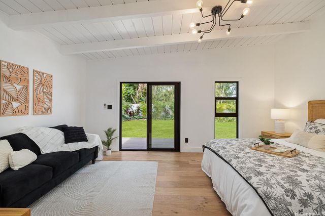 a bedroom with a large bed and a couch