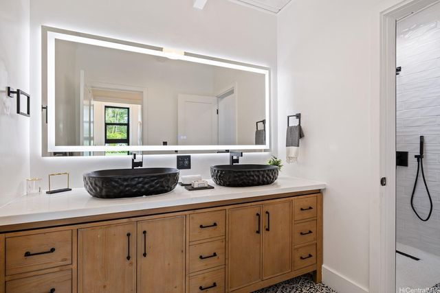 a bathroom with a granite countertop sink and a mirror