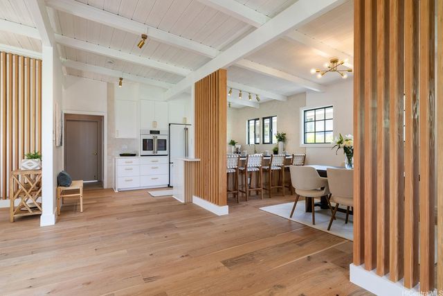 a view of kitchen with furniture and a refrigerator