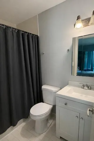 a spacious bedroom with a bed and glass door