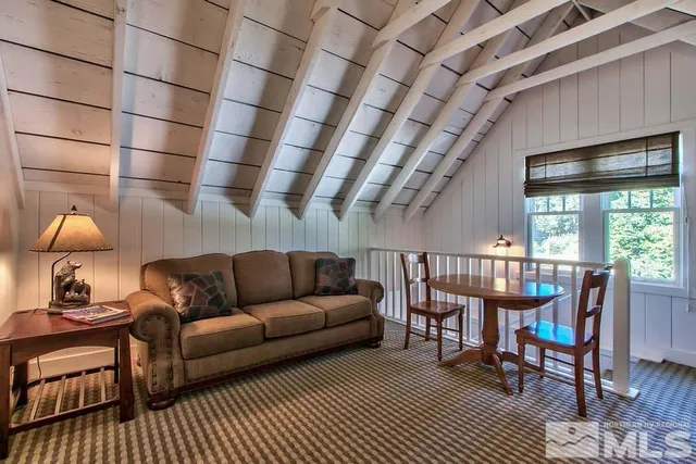 a view of backyard with outdoor seating and trees