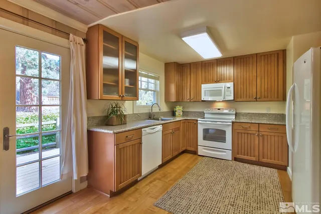 a living room with a large window and furniture