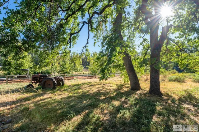 an aerial view of a house with a yard and lake