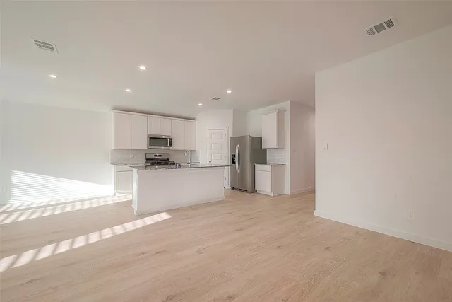 a view of kitchen with refrigerator sink and stove