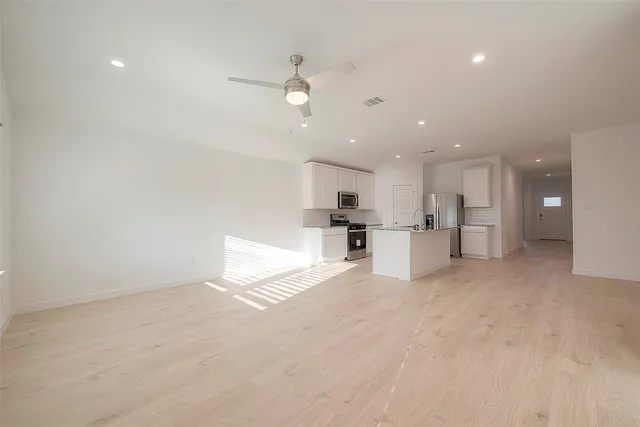 a view of kitchen with refrigerator and window