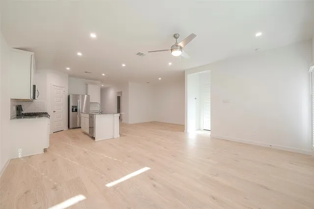 a view of kitchen with refrigerator and window