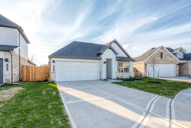 a view of a house with a yard and pathway