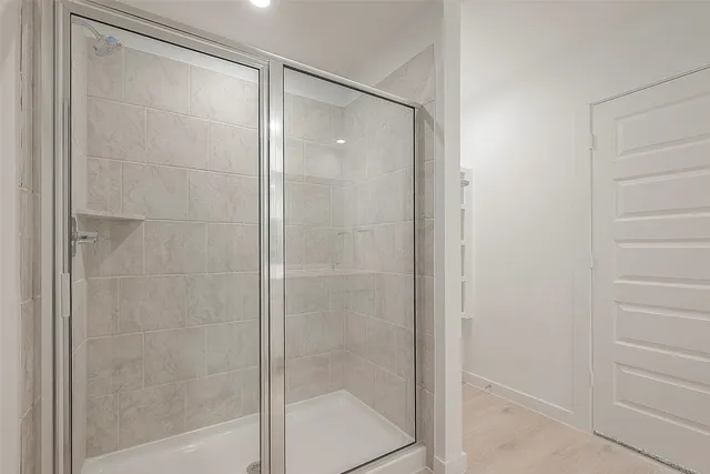 a bathroom with a glass shower door