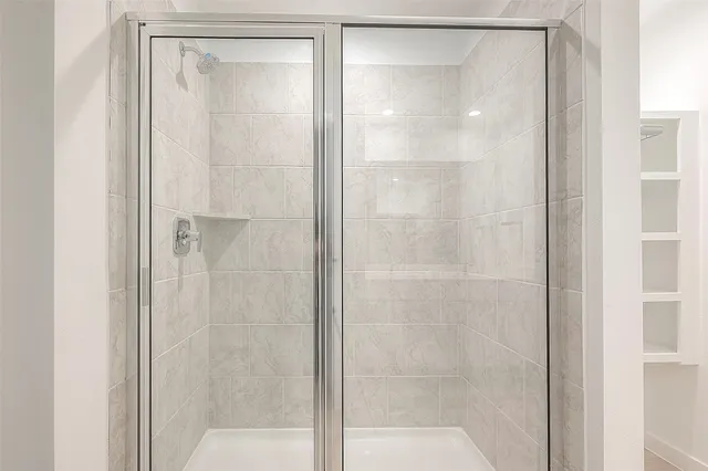 a bathroom with a glass shower door