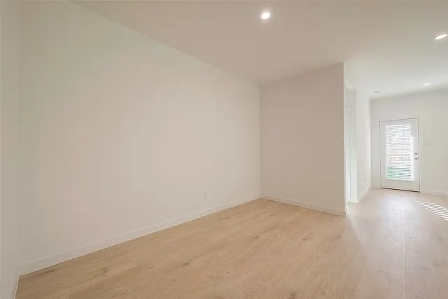 a view of an empty room and wooden floor