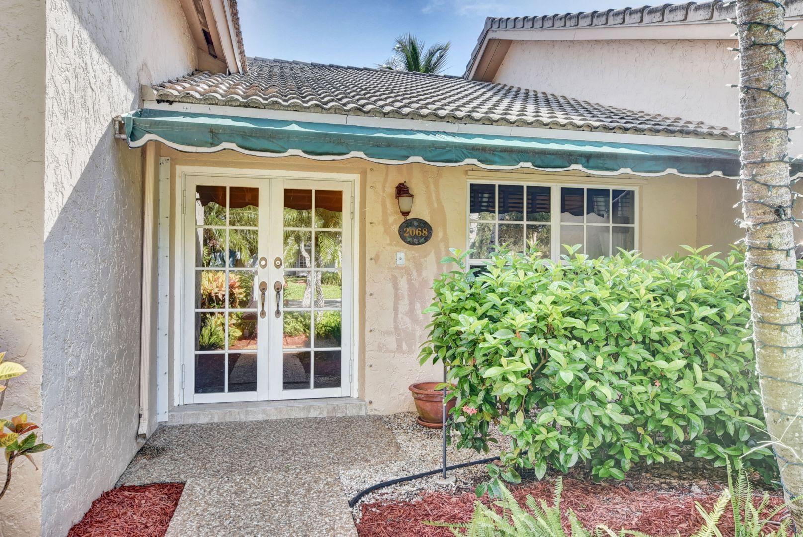 2068 Southwest 8th Avenue Boca Raton, FL 33486 - Photo 2 of 35 a front view of a building