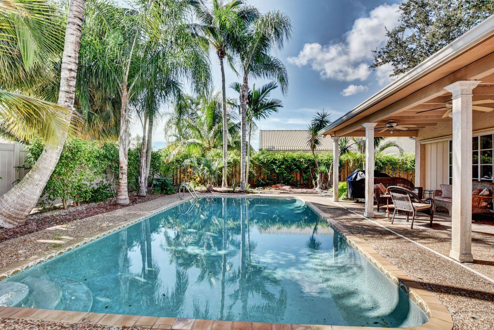 2068 Southwest 8th Avenue Boca Raton, FL 33486 - Photo 31 of 35 a swimming pool with outdoor seating and yard