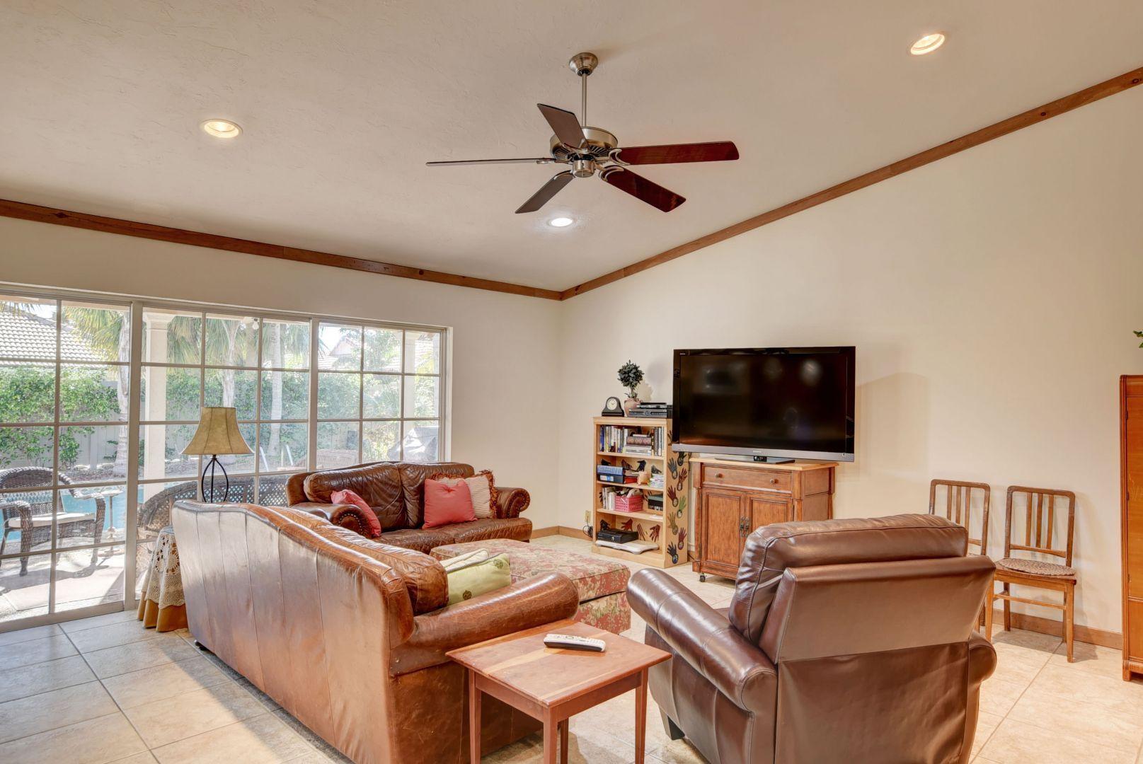 2068 Southwest 8th Avenue Boca Raton, FL 33486 - Photo 9 of 35 a living room with furniture and a flat screen tv