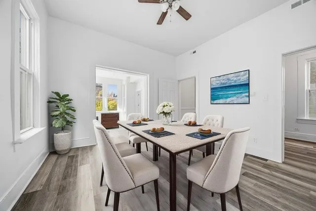a dining room with furniture a rug and wooden floor