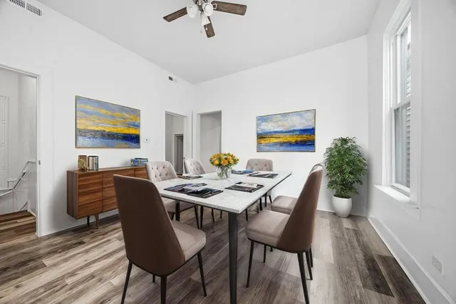 a view of a dining room with furniture window and wooden floor