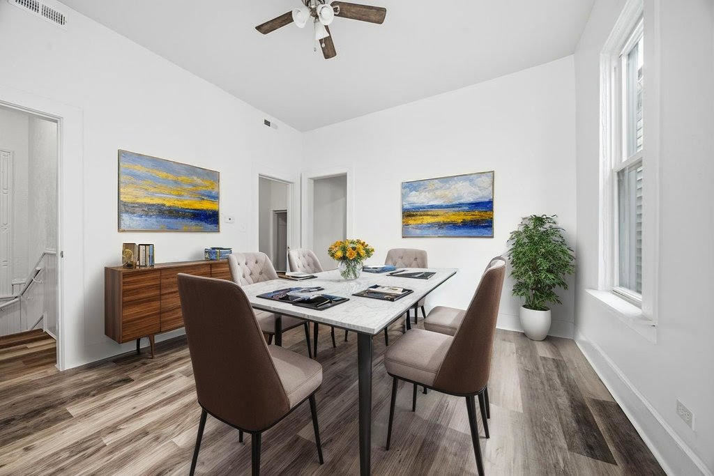 8919 South Exchange Avenue Chicago, IL 60617 - Photo 20 of 41 a view of a dining room with furniture window and wooden floor