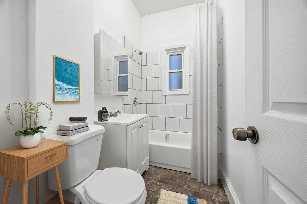 8919 South Exchange Avenue Chicago, IL 60617 - Photo 24 of 41 a bathroom with a sink toilet and shower