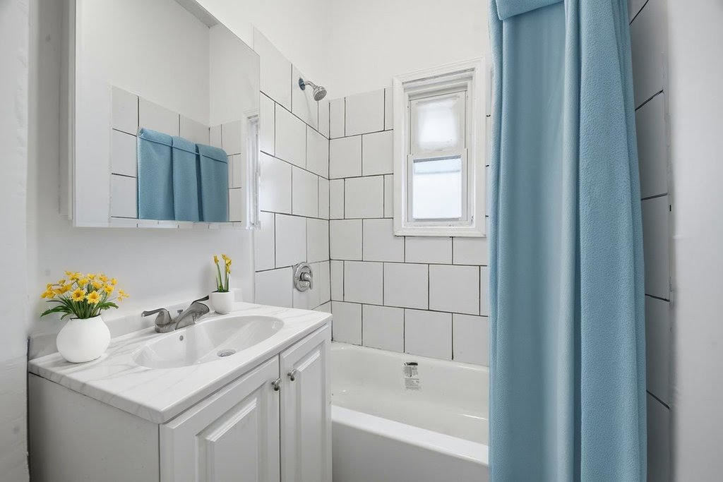 8919 South Exchange Avenue Chicago, IL 60617 - Photo 26 of 41 a bathroom with a sink and a bathtub