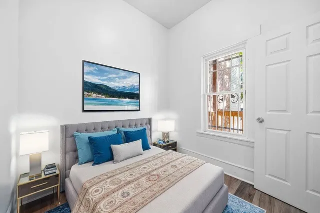 a bedroom with a bed and a window