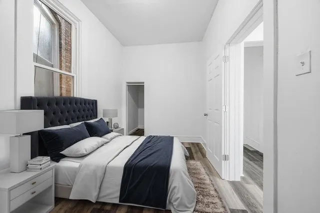 a bedroom with a bed and a window