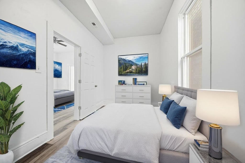 8919 South Exchange Avenue Chicago, IL 60617 - Photo 31 of 41 a bedroom with a bed and a flat screen tv