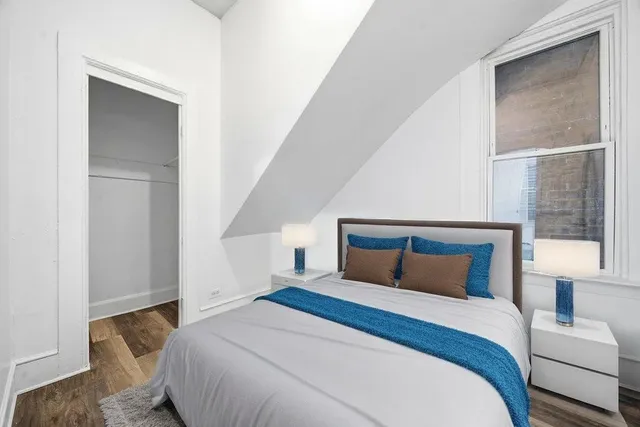 a bedroom with a bed and a window