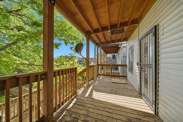 a view of a porch with wooden floor and outdoor space