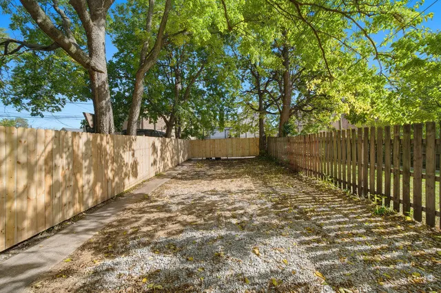 a backyard of a house with a tree