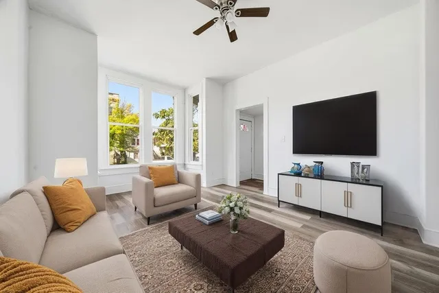 a living room with furniture and a flat screen tv