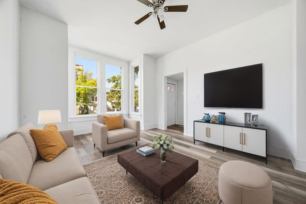 8919 South Exchange Avenue Chicago, IL 60617 - Photo 4 of 41 a living room with furniture and a flat screen tv