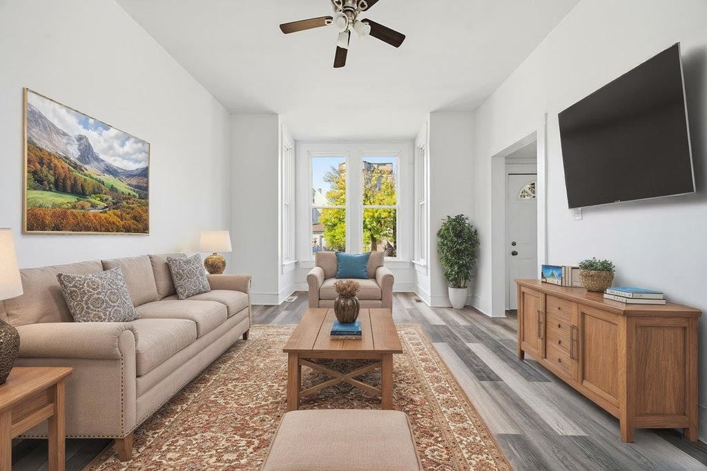8919 South Exchange Avenue Chicago, IL 60617 - Photo 5 of 41 a living room with furniture and a flat screen tv