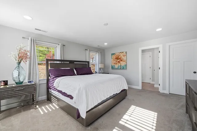 a spacious bedroom with a bed and a window