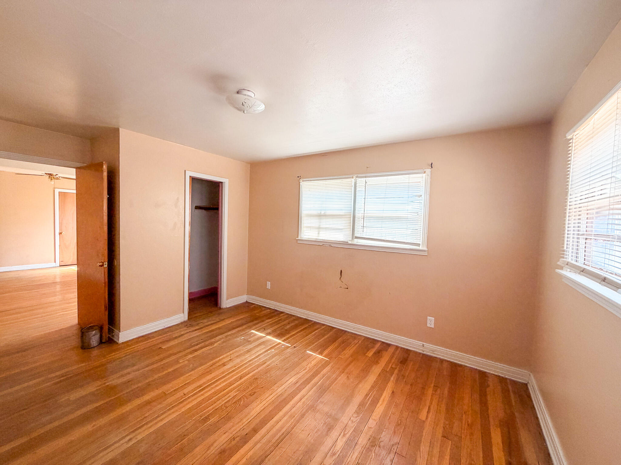 3207 Amherst Street Lubbock, TX 79415 - Photo 10 of 16 an empty room with wooden floor and windows