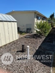 491 Mill Road, Unit 36 Sequim, WA 98382 - Photo 7 of 21 a view of a house with backyard and trees