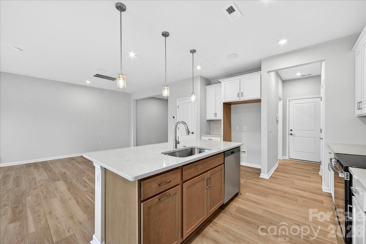 512 Webster Lane Cramerton, NC 28032 - Photo 8 of 28 a kitchen with a sink chandelier and refrigerator