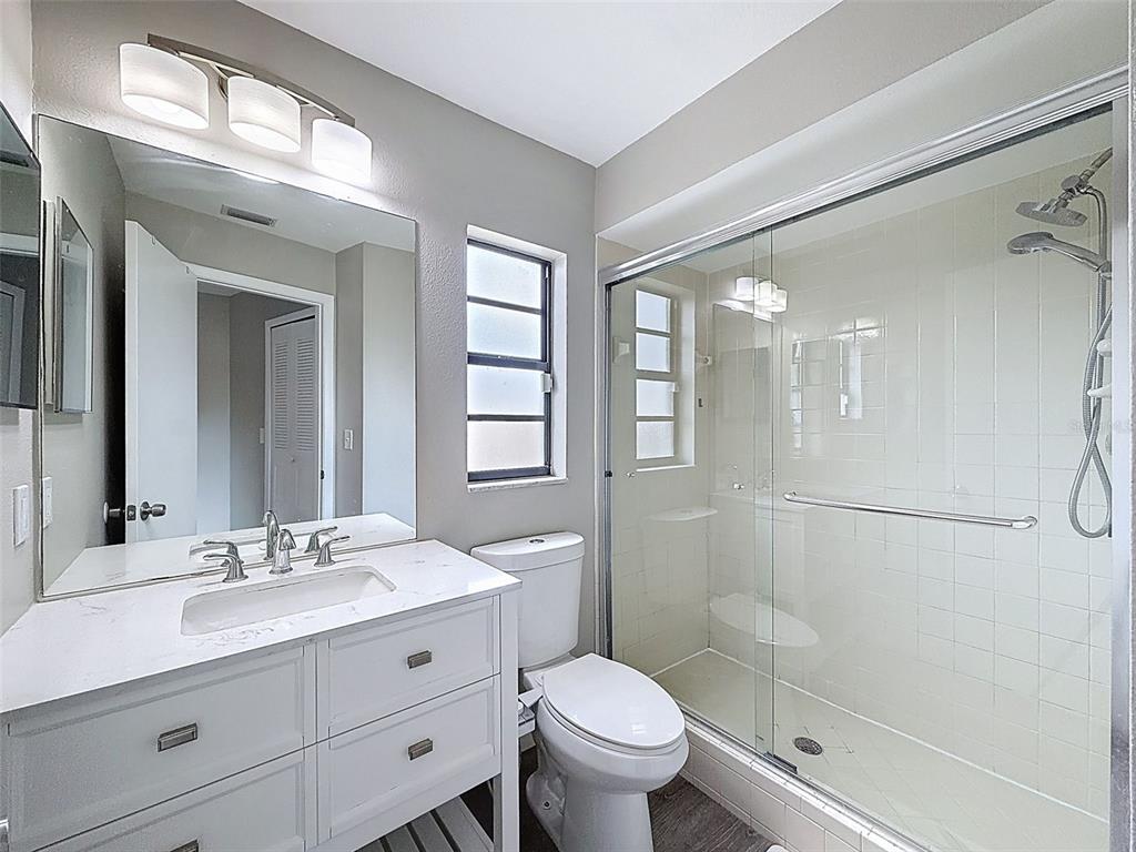 5384 Baldock Avenue Spring Hill, FL 34608 - Photo 28 of 51 a bathroom with a double vanity sink toilet mirror and shower
