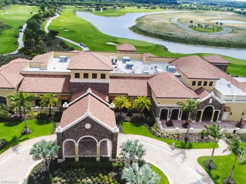 9727 Acqua Court, Unit 427 Naples, FL 34113 - Photo 17 of 29 a view of house with garden space and car parked