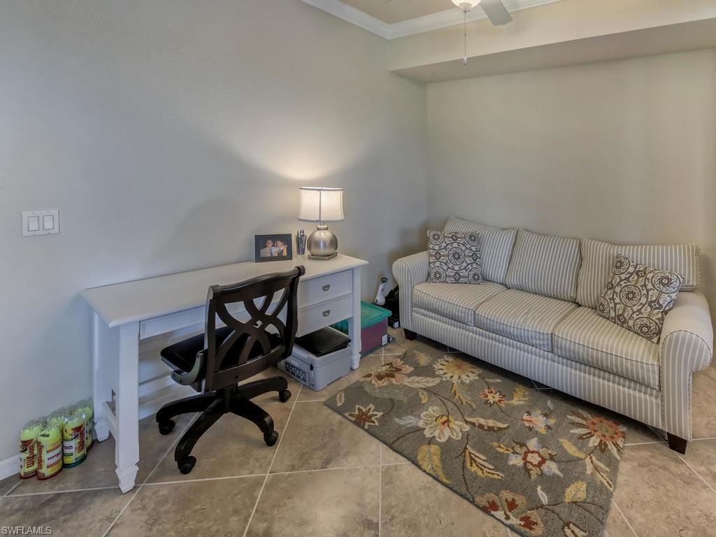 9727 Acqua Court, Unit 427 Naples, FL 34113 - Photo 24 of 29 a living room with furniture and a rug