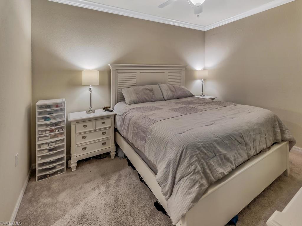 9727 Acqua Court, Unit 427 Naples, FL 34113 - Photo 27 of 29 a bedroom with a bed and a couch