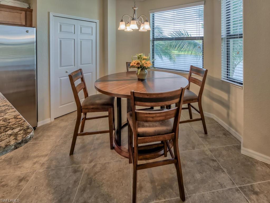 9727 Acqua Court, Unit 427 Naples, FL 34113 - Photo 28 of 29 a view of a dining room with furniture and window