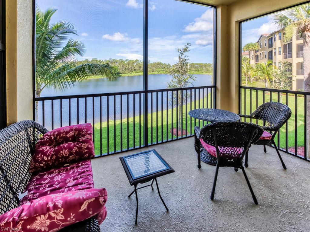 9727 Acqua Court, Unit 427 Naples, FL 34113 - Photo 6 of 29 a view of a porch with furniture and a yard