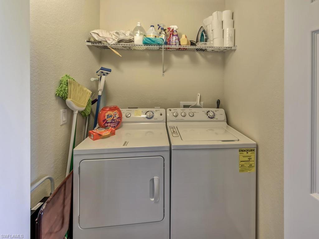 9727 Acqua Court, Unit 427 Naples, FL 34113 - Photo 7 of 29 a utility room with dryer and washer