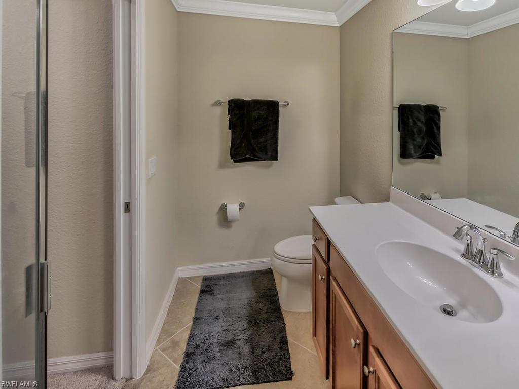 9727 Acqua Court, Unit 427 Naples, FL 34113 - Photo 10 of 29 a bathroom with a sink toilet and mirror