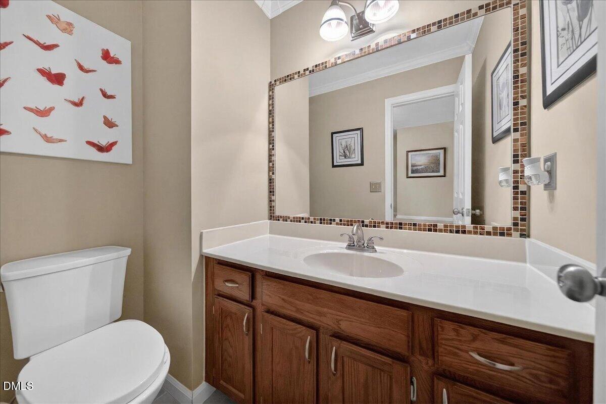 9536 Bells Valley Drive Raleigh, NC 27617 - Photo 15 of 39 a bathroom with a granite countertop sink mirror vanity and toilet