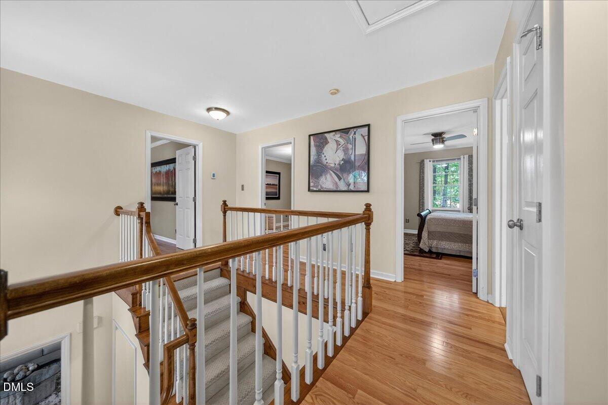 9536 Bells Valley Drive Raleigh, NC 27617 - Photo 18 of 39 a view of a hallway with wooden floor and stairs